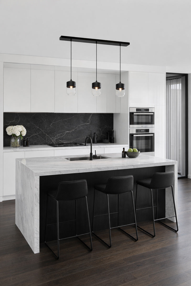 Rectangular linear 3 drop pendant with clear glass shades in a sleek kitchen 