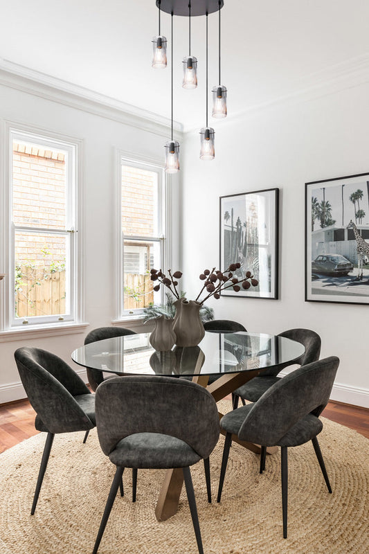 Clear glass multi drop pendant over a dining space. 
