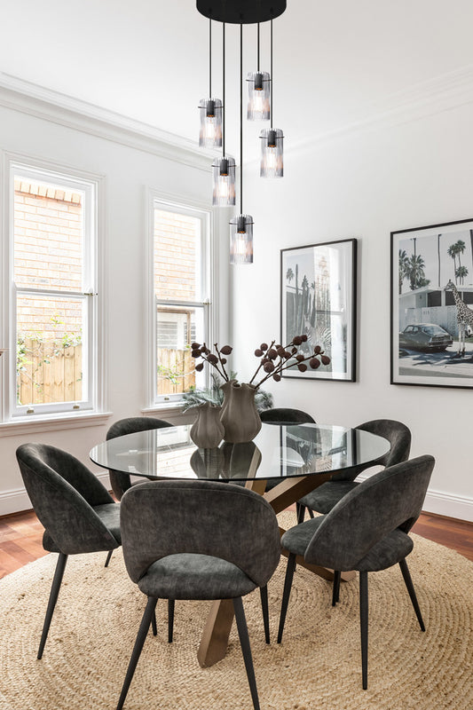 Clear glass multi drop pendant over a dining space. 