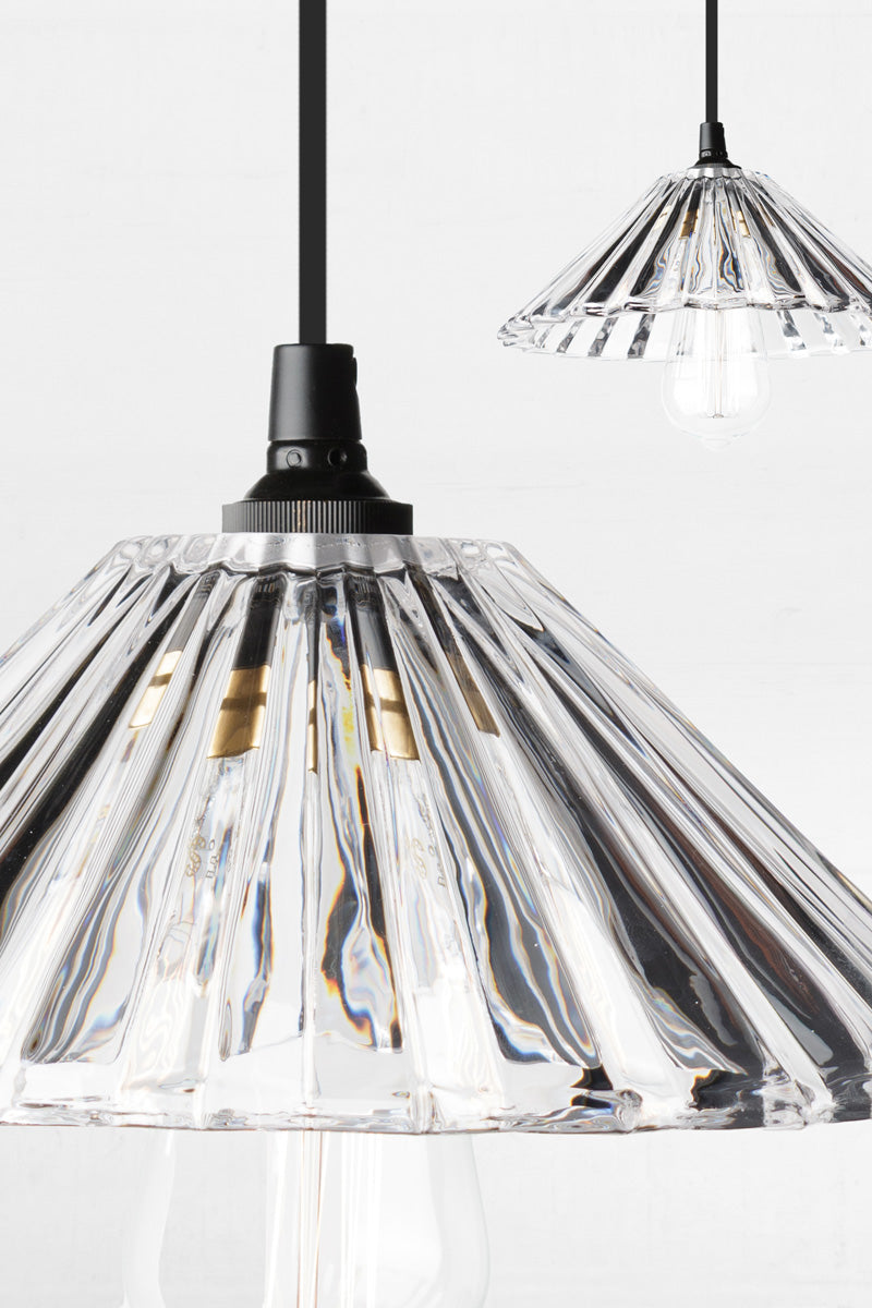 Close up o the pleated detailing on the clear glass shade. 