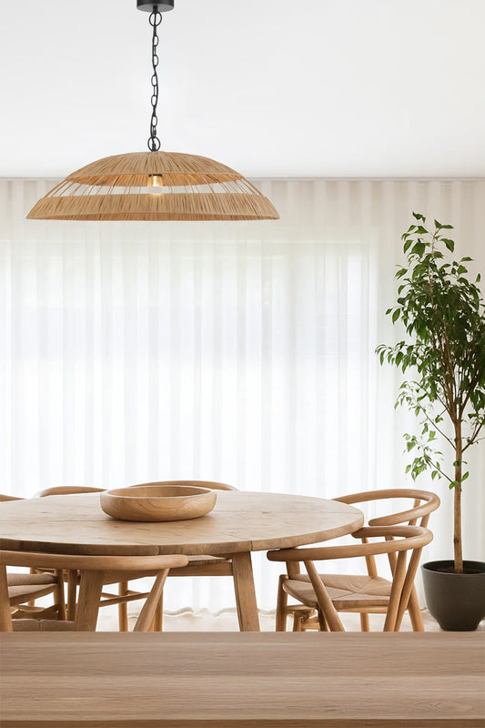 Large woven shade with black chain/cord pendant cord over an airy dining table