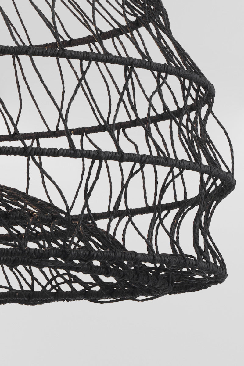 Close up of black woven pendant light showing intricate handwoven open weave texture detail