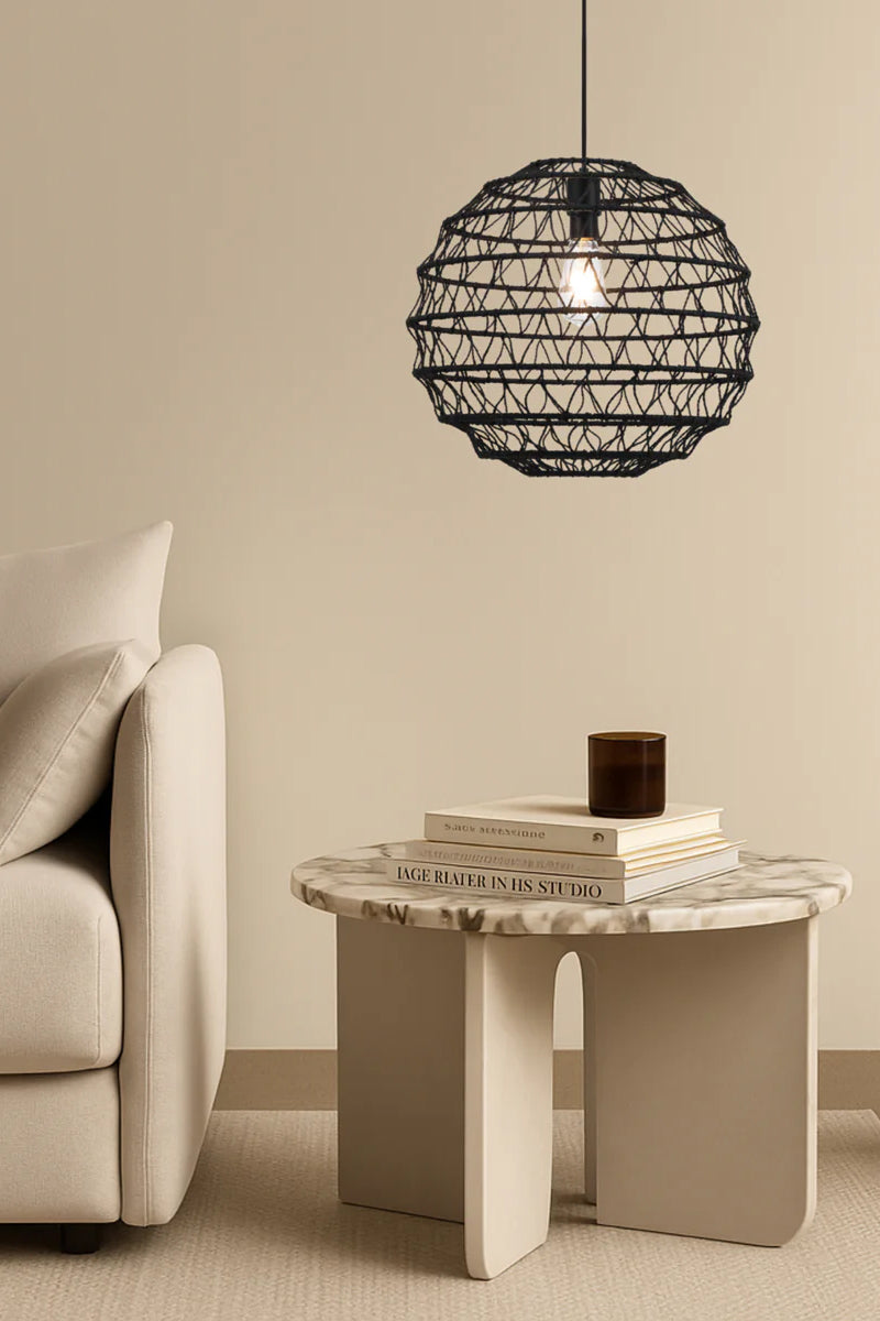 Black woven pendant light styled in modern neutral interior with soft ambient lighting