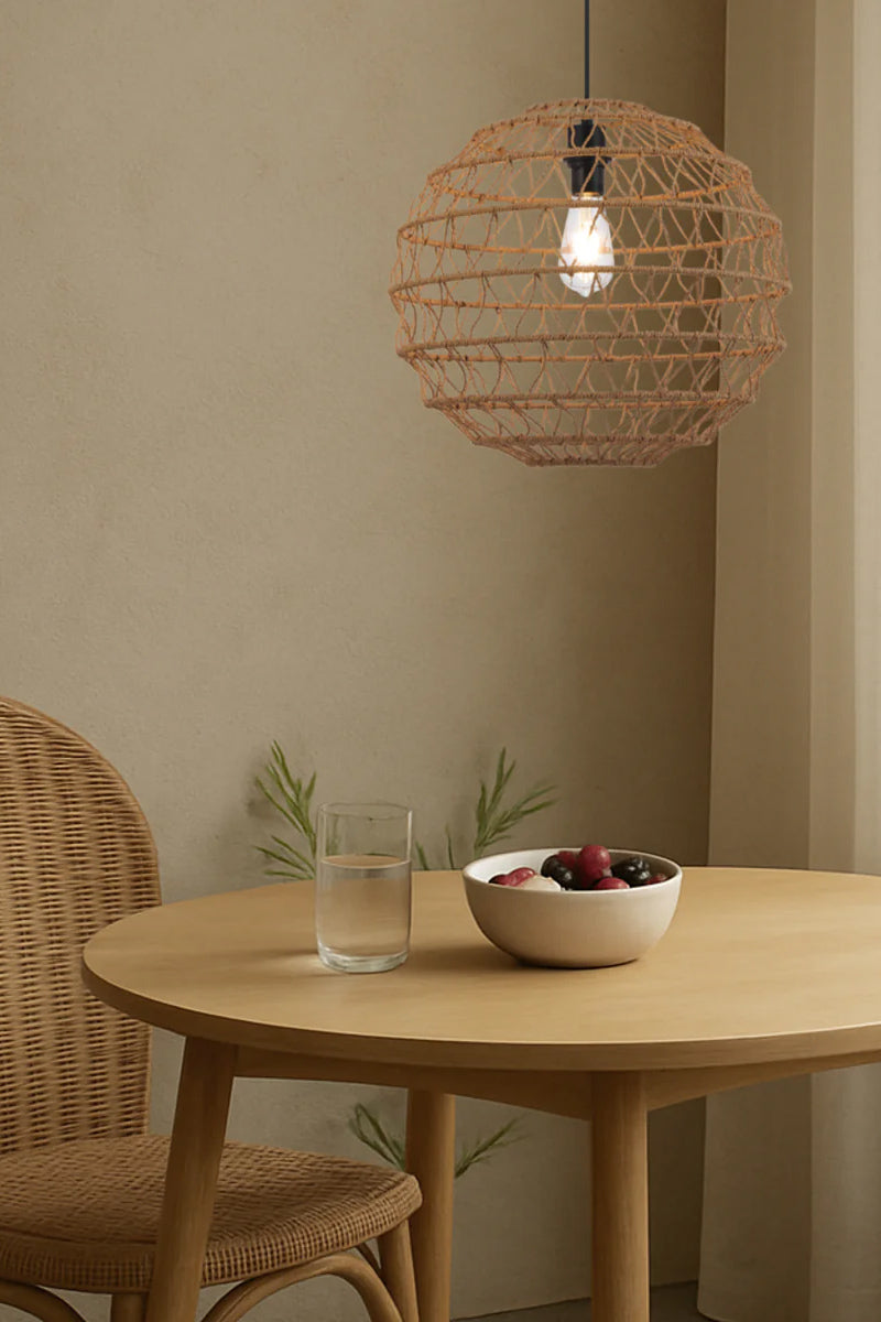 Small coastal rattan pendant light styled in neutral dining room with warm organic woven texture