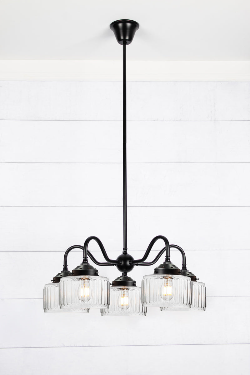 Black five arm gooseneck chandelier with  five Capri Clear glass shades featuring fluted detailing.