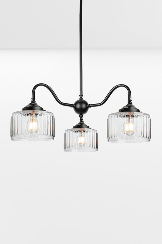Black three arm gooseneck chandelier with  three Capri Clear glass shades featuring fluted detailing.