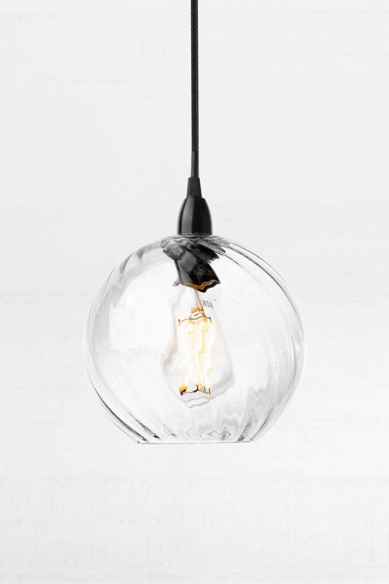Kansas Glass Pendant Light with clear twisted globe shade, black metalware and black braided cord