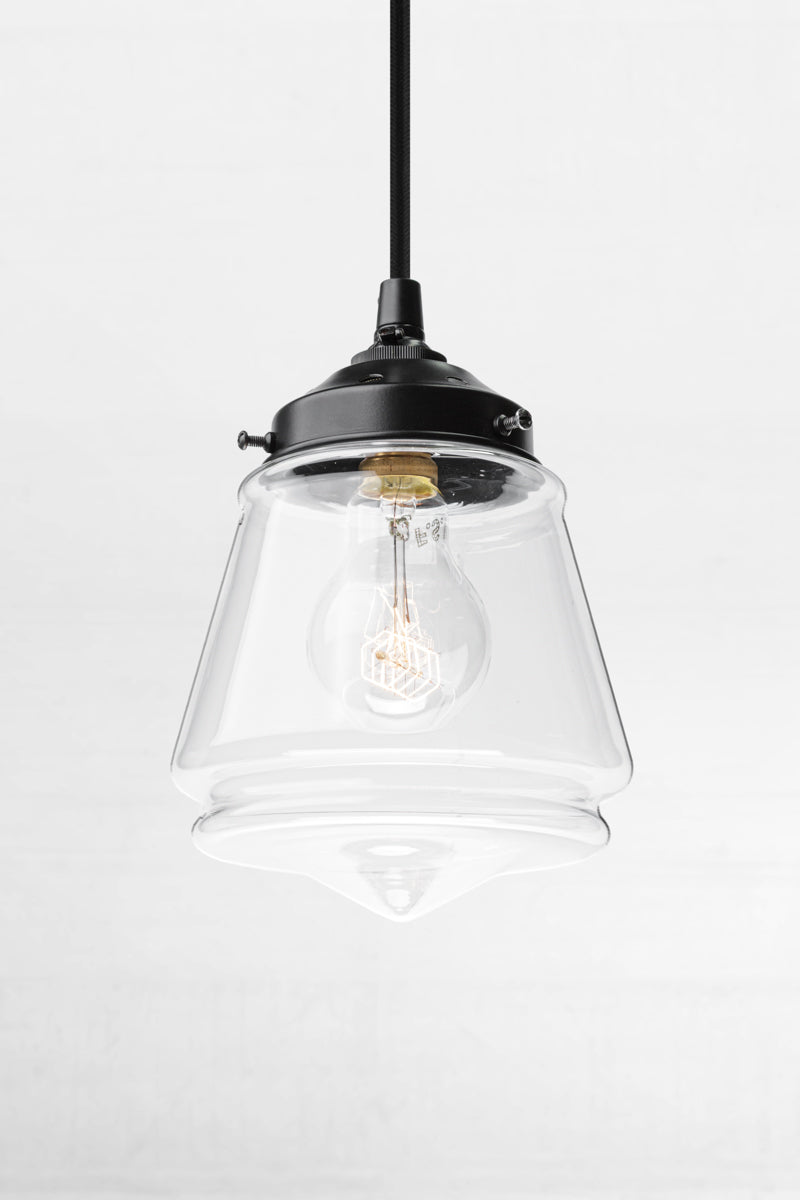 Clear glass Mae Deco Glass Shade paired with a black gallery, cloth cord and clear A60 bulb. 
