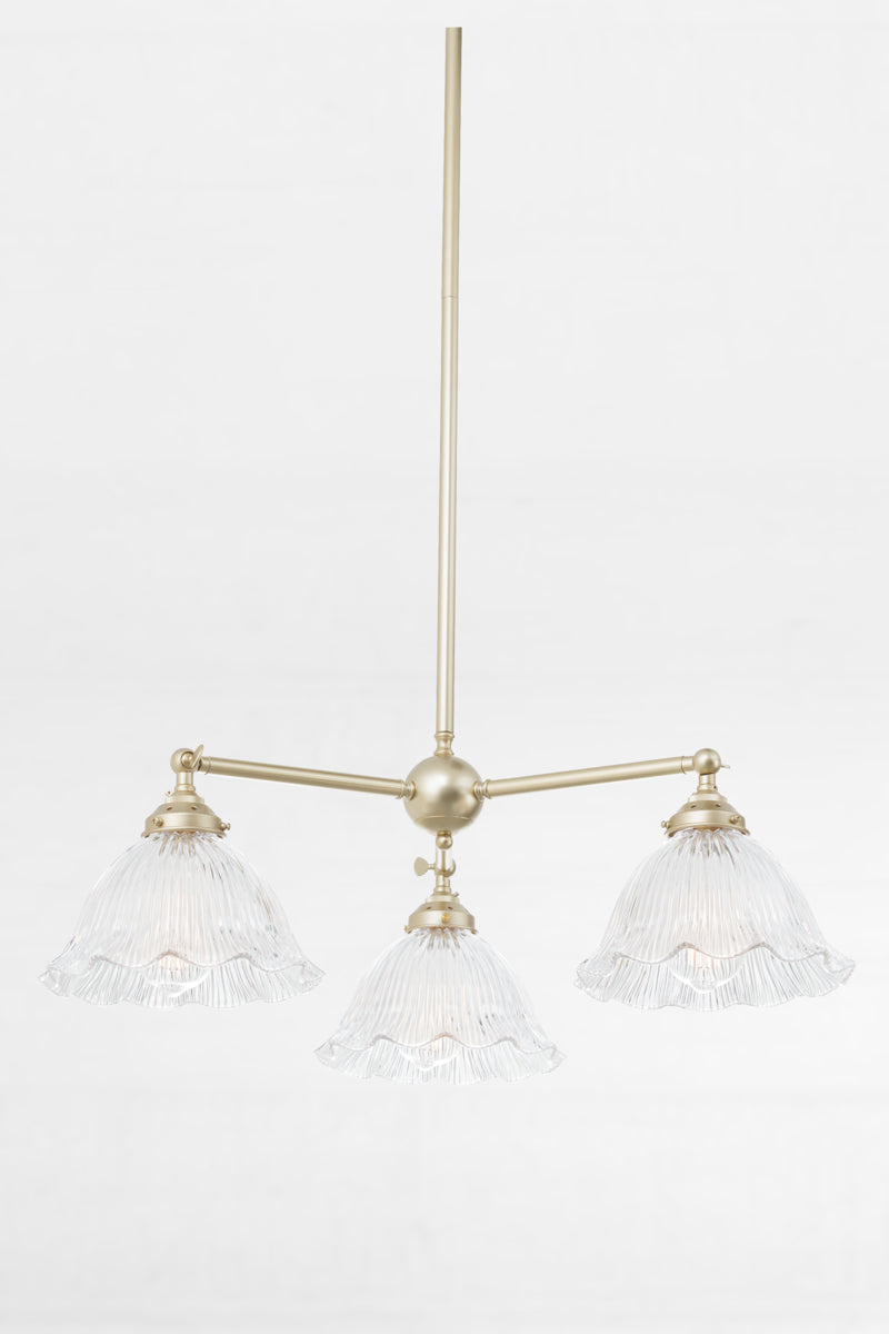 Gold/brass 3 arm chandelier with adjustable lampholders, paired with reeded clear glass shades with a frilled edge