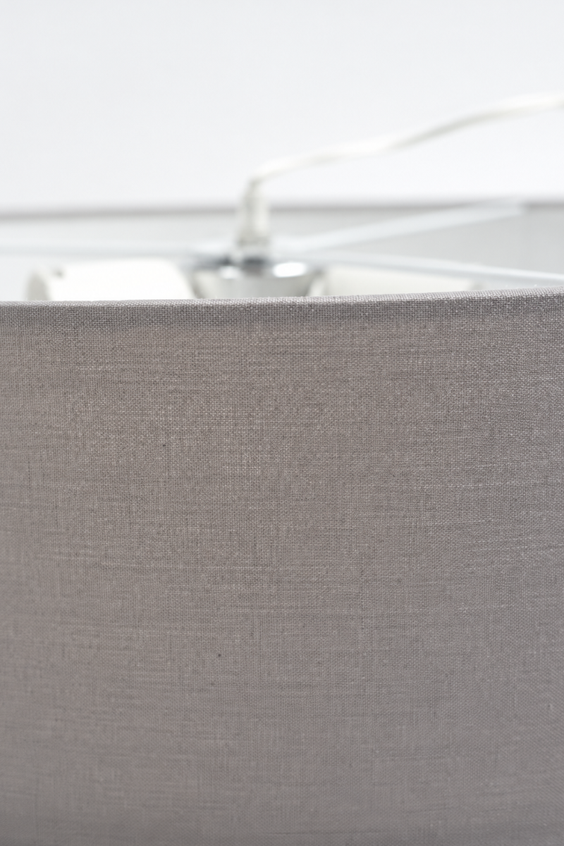 Close-up of the grey fabric drum shade on the Clemente pendant light highlighting the woven fabric texture.