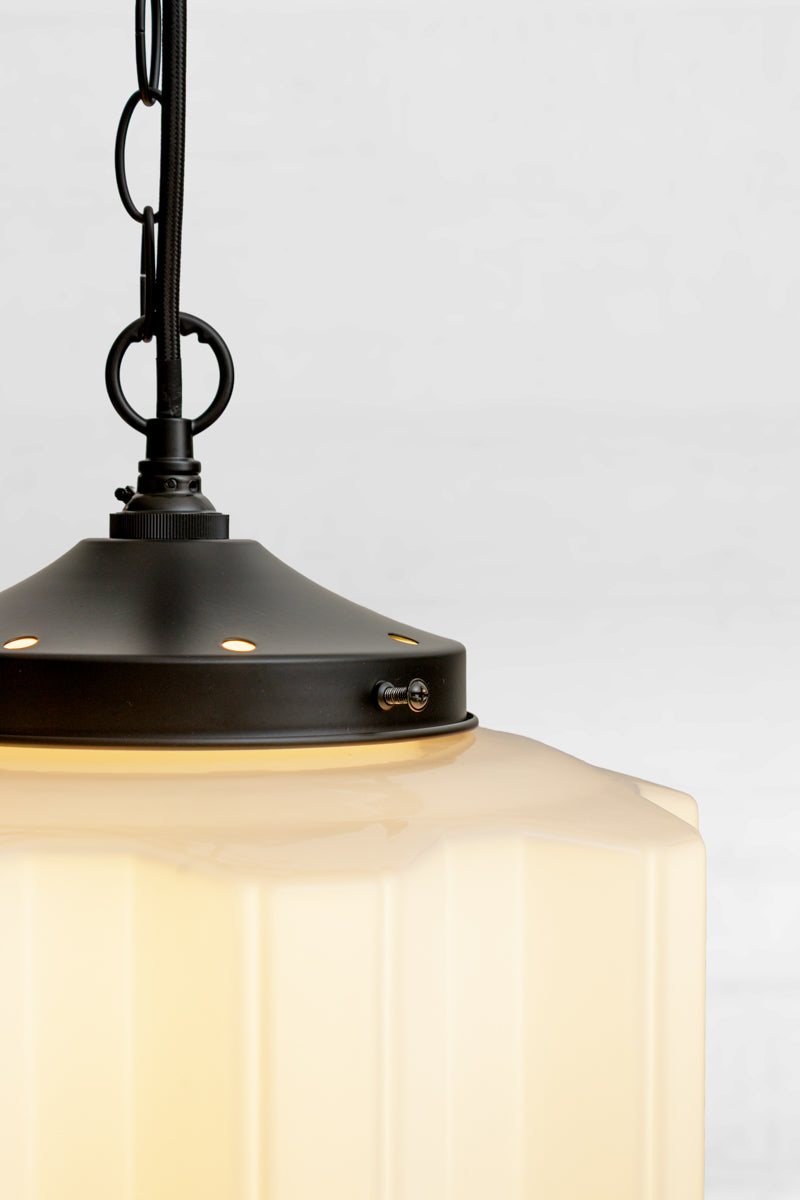Close up of the black gallery and chain holding the opal shade. 