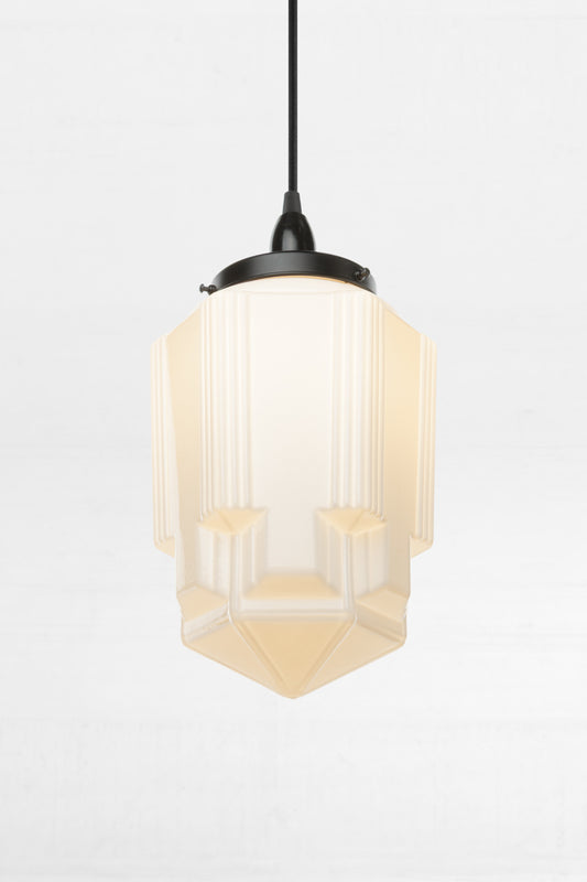 Sculptural glass shade with geometric elegance and detailing. a nod to Art deco design