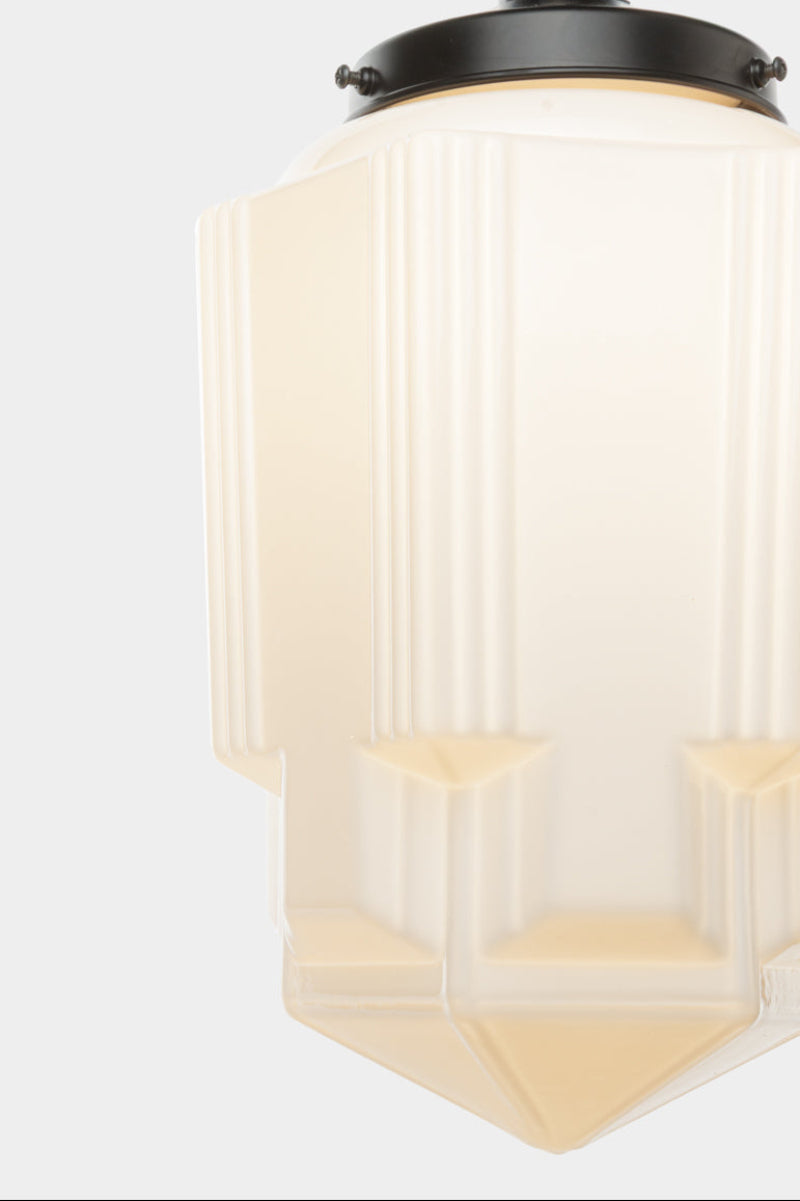 Close up of the Art Deco opal glass Tivoli shade with a lack gallery. 