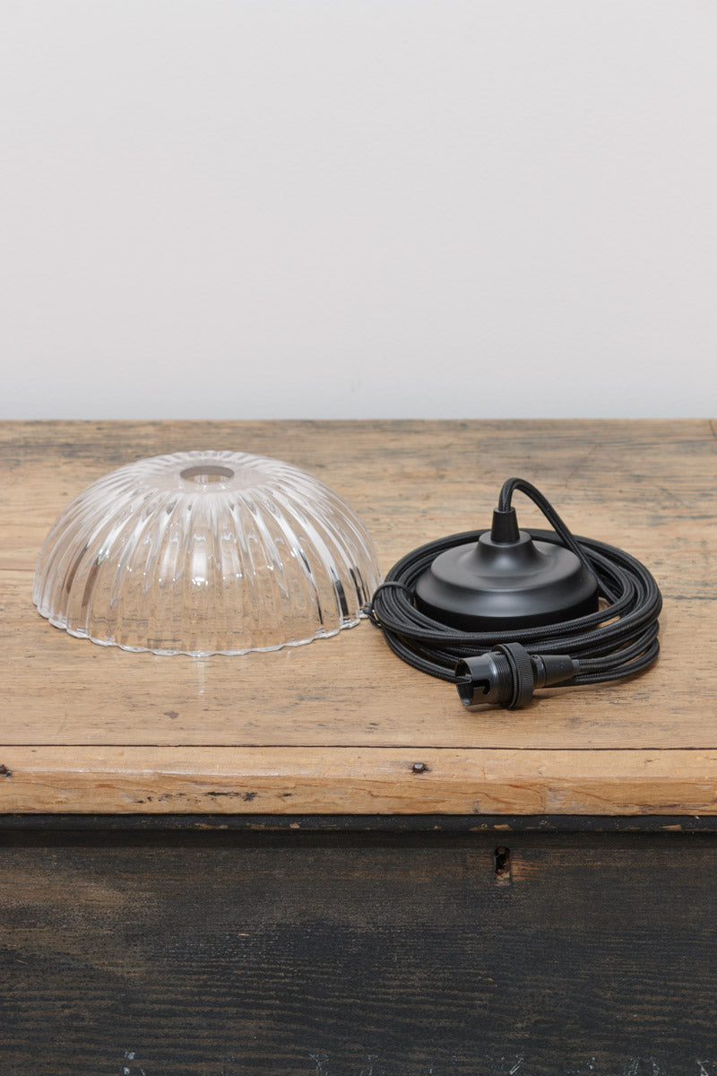Deloraine clear pressed glass shade displayed with interchangeable pendant cord and ceiling rose finish options.