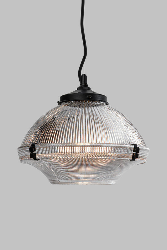 Glass Pendant Light with layered clear prismatic glass shade, black retaining clamps and matt black cable/ cord suspension against a light grey background.