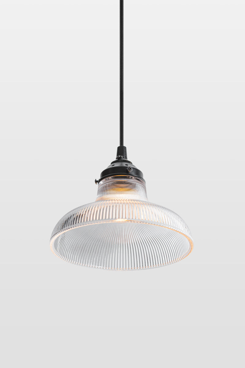 Small clear holohpane glass shade on a black braided cloth cord with black hardware. 