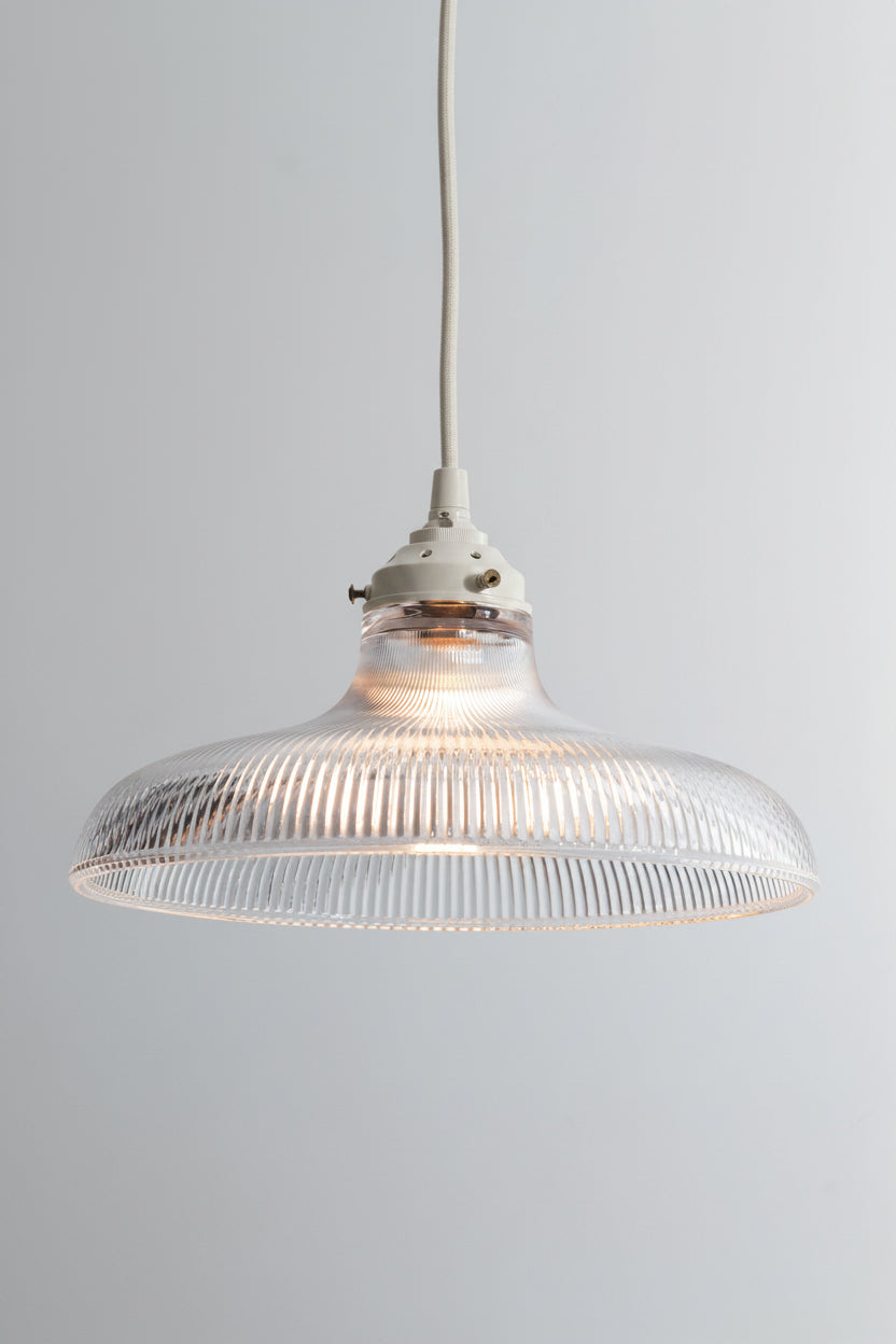 large reeded shade with white pendant cord