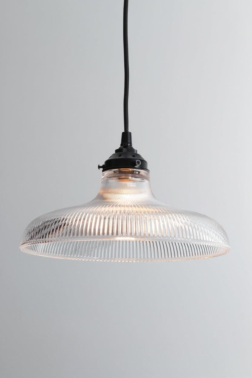 Large clear holohpane glass shade on a black braided cloth cord with black hardware. 