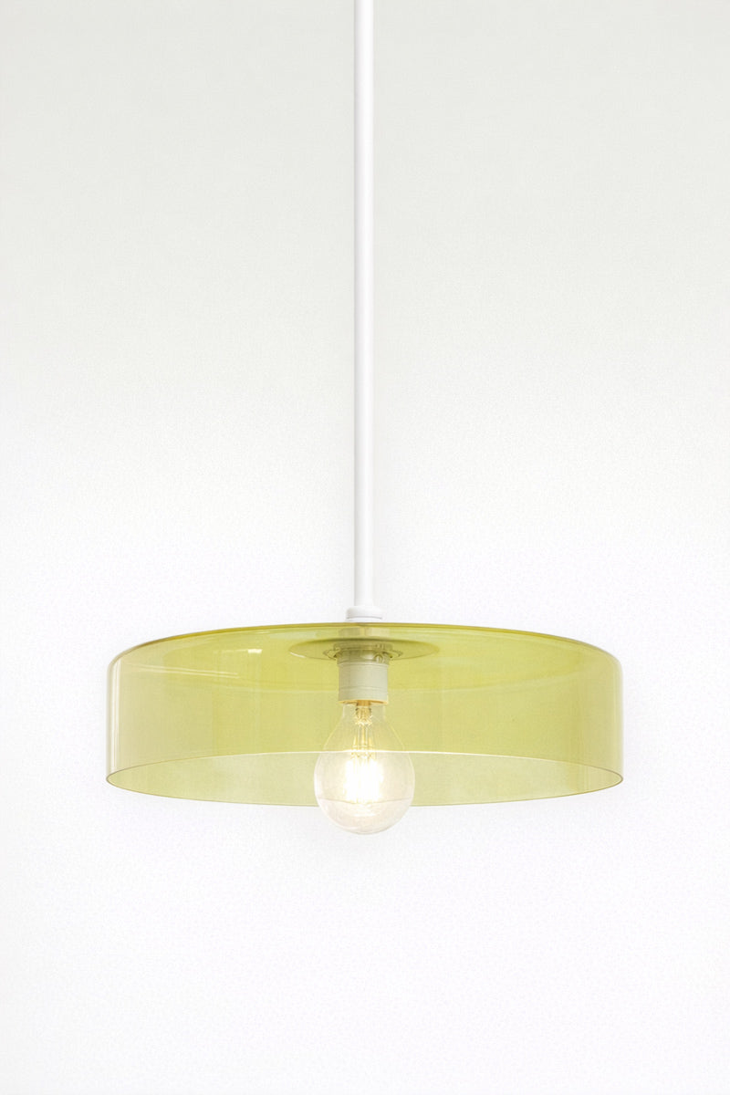 A green glass shade on white pole pendant  saturating a surface with light without obscuring it 