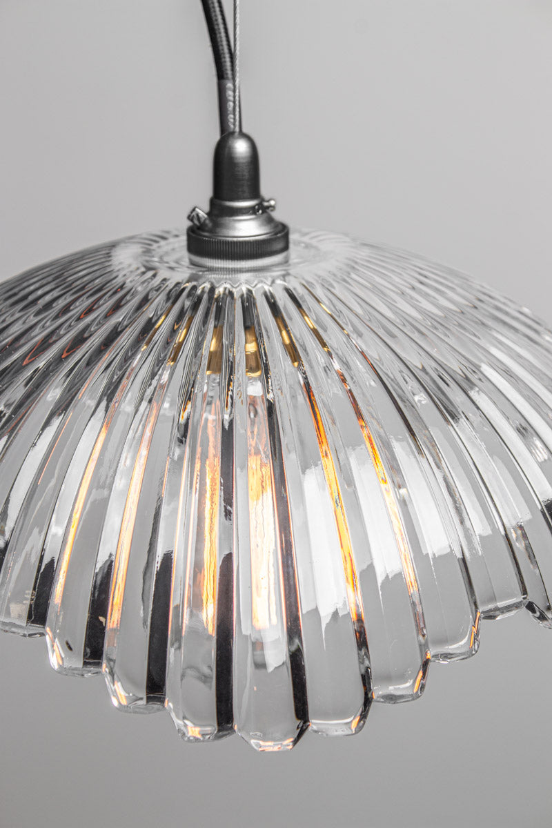 Close-up of Hepburn Glass Pendant Light with black lampholder, clear vertically fluted glass shade and exposed bulb