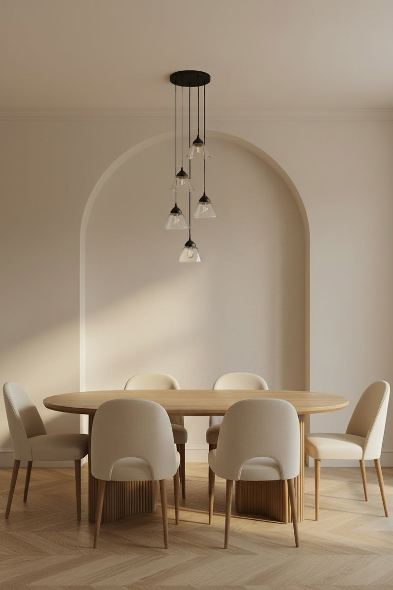 Pendant Light featuring five clear glass shades with black suspension cords, installed over a modern dining space. 