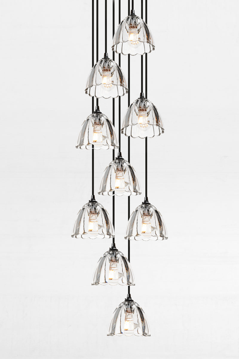 Clear Glass Multi Drop Chandelier in nine light configuration featuring cascading clear textured glass shades and black ceiling rose.