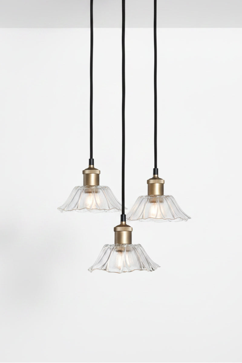 Honfleur Glass Multi Drop Pendant with 3 clear fluted glass shades suspended at staggered heights from a black round ceiling rose on gold brass cords