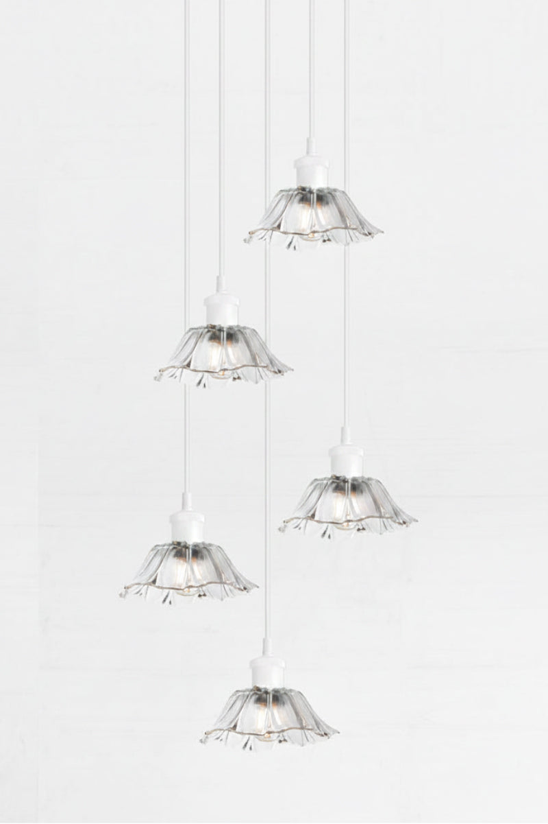 Honfleur Glass Multi Drop Pendant in white  with five clear fluted glass shades suspended at staggered heights from a black round ceiling rose.