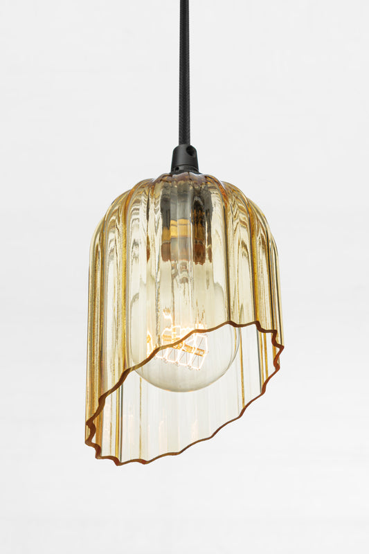 Shade opening view of the amber glass elongated shade with fluted detailing and featuring an angle cut.