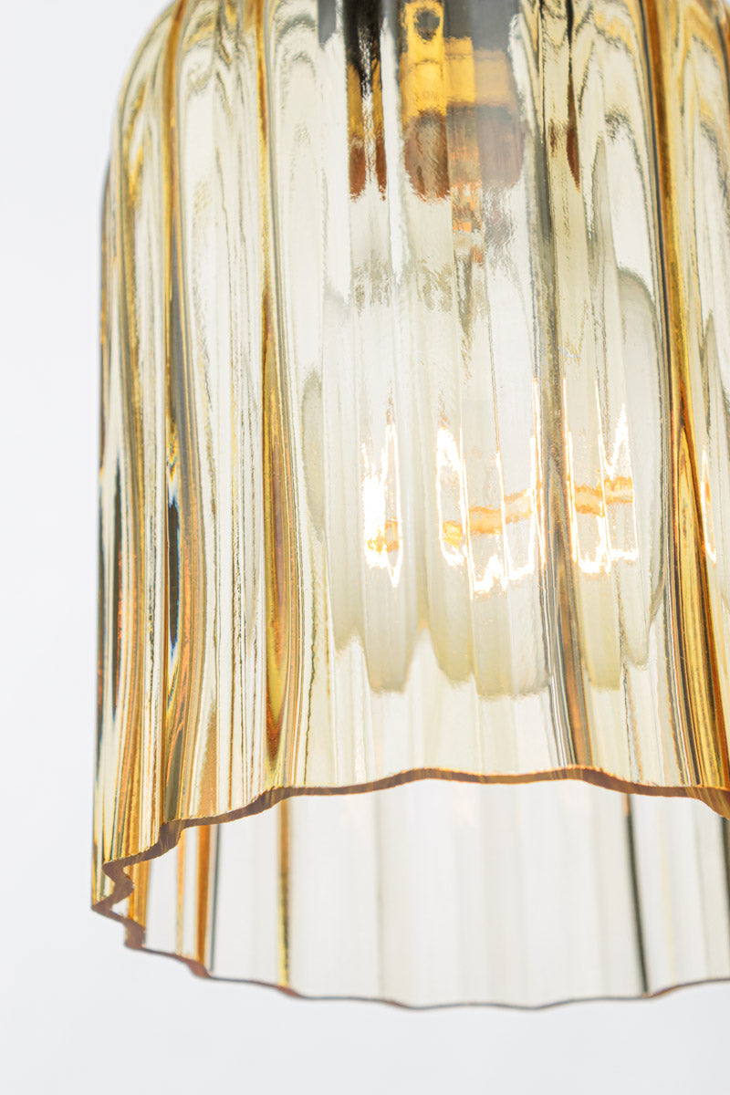 Close up of the amber glass shade, showcasing the fluted detailing. 