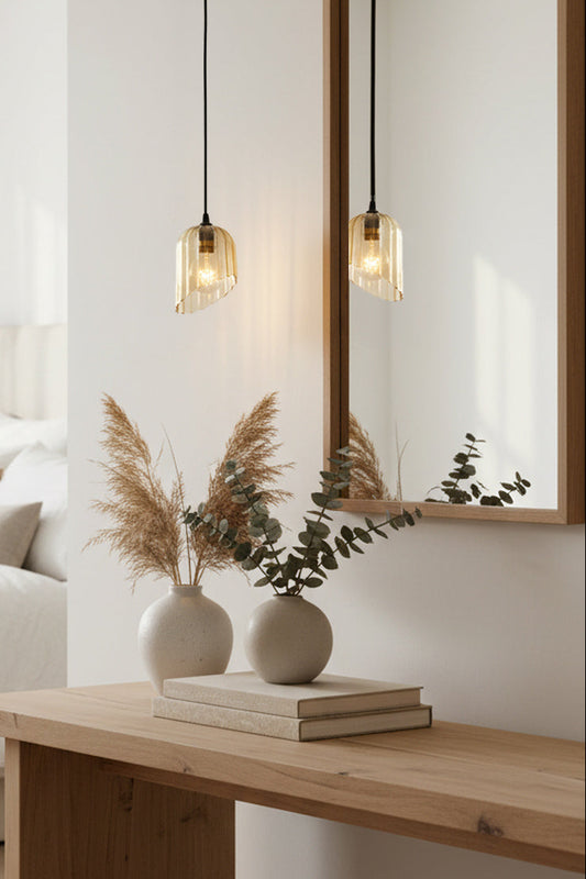 modern bedroom with amber glass pendant light over console table