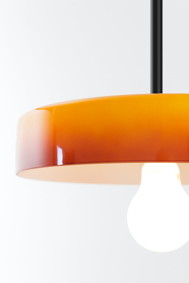 Close up of the amber glass shade with black pole suspension. 