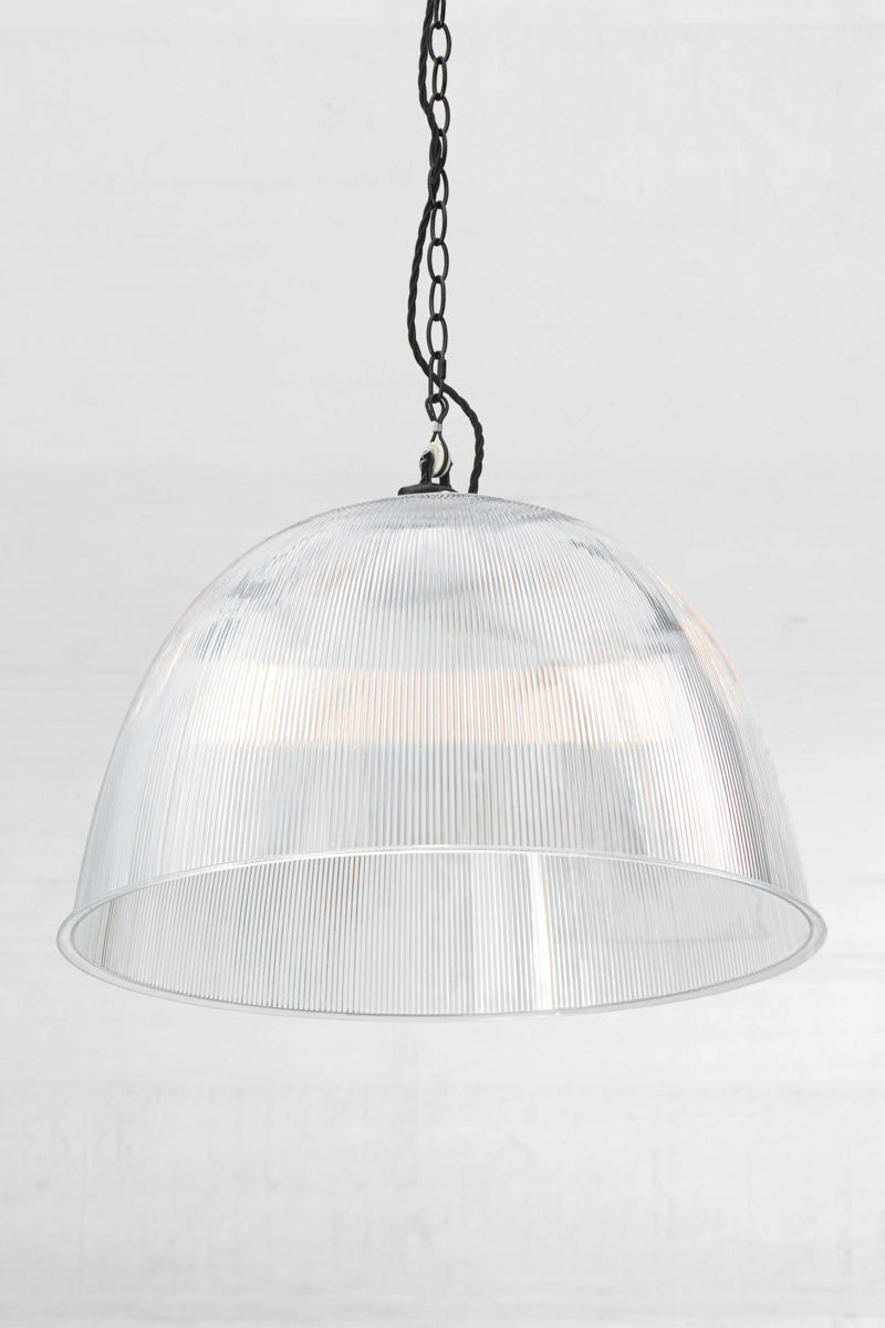 Angled view of the large clear prismatic pendant with black industrial chain style pendant suspension