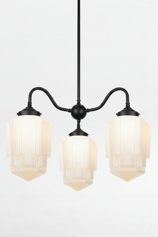 Art Deco opal glass Tivoli shades paired with a black gooseneck chandelier fixture. 