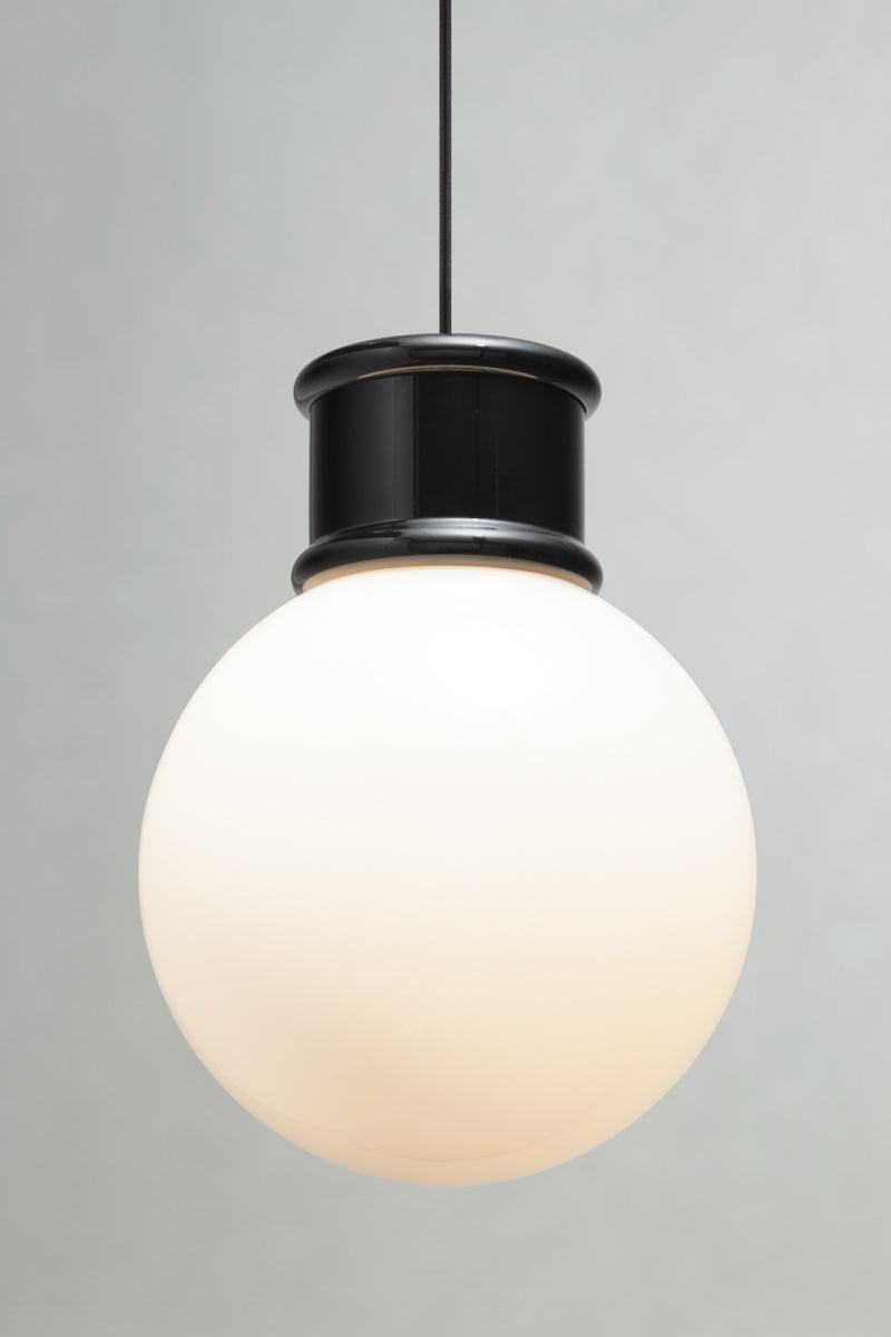 Front view of the large opal glass ball shade paired with a black topper and pendant cord. 