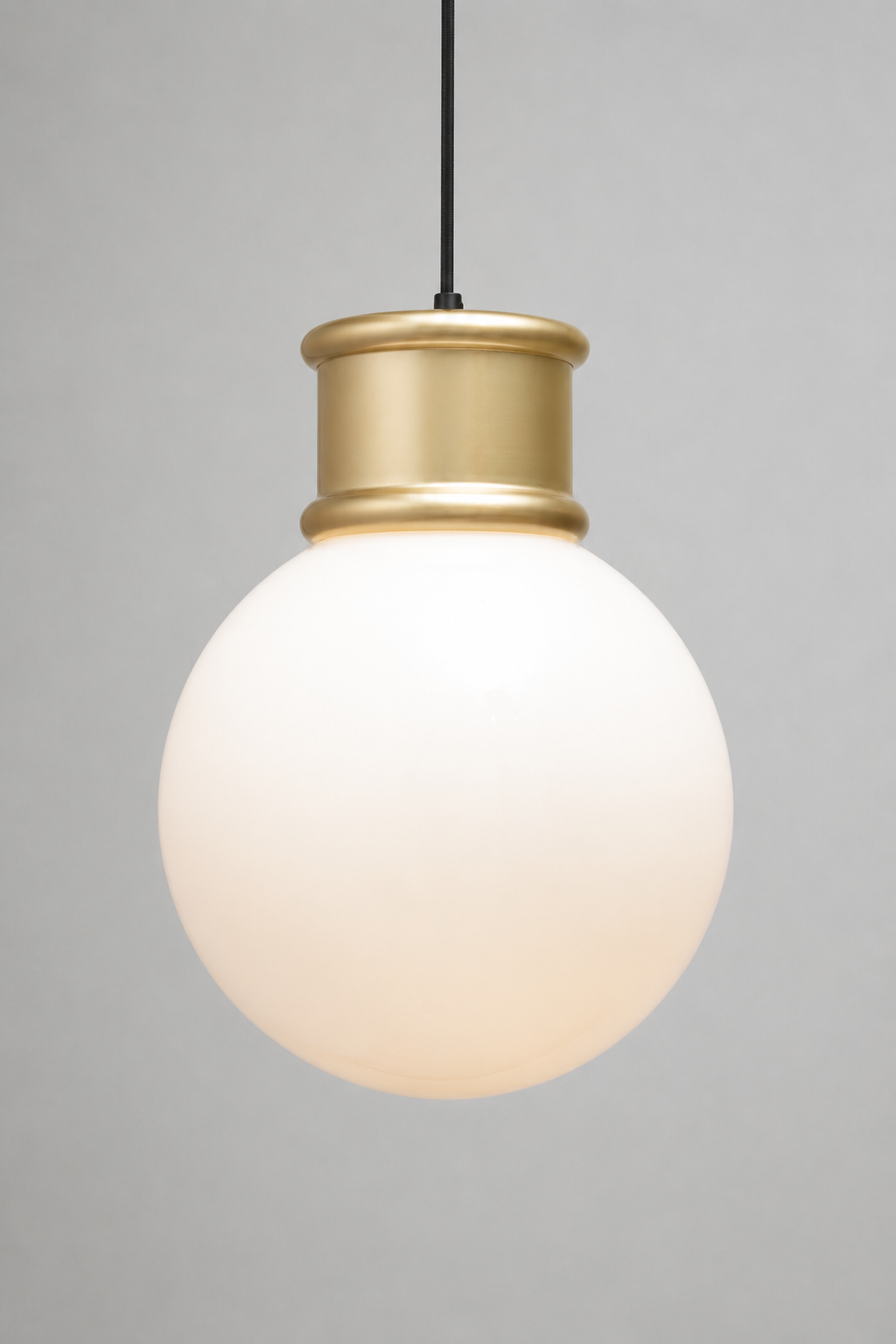Large opal glass ball shade paired with a gold/brass topper and pendant cord. 