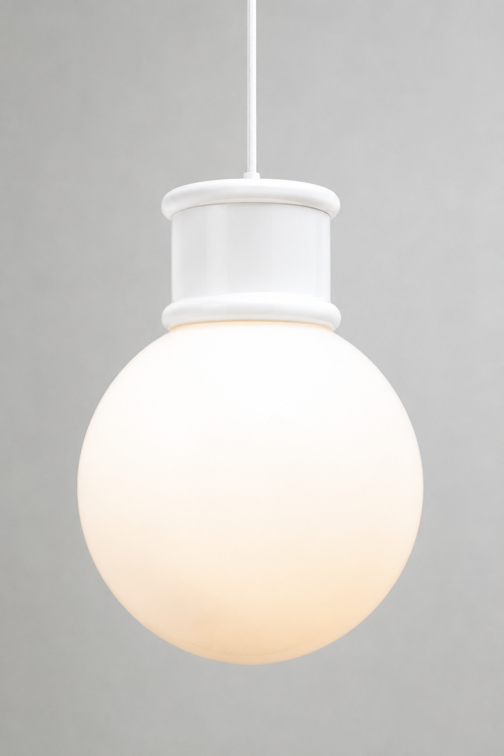 Large opal glass ball shade paired with a white topper and pendant cord. 