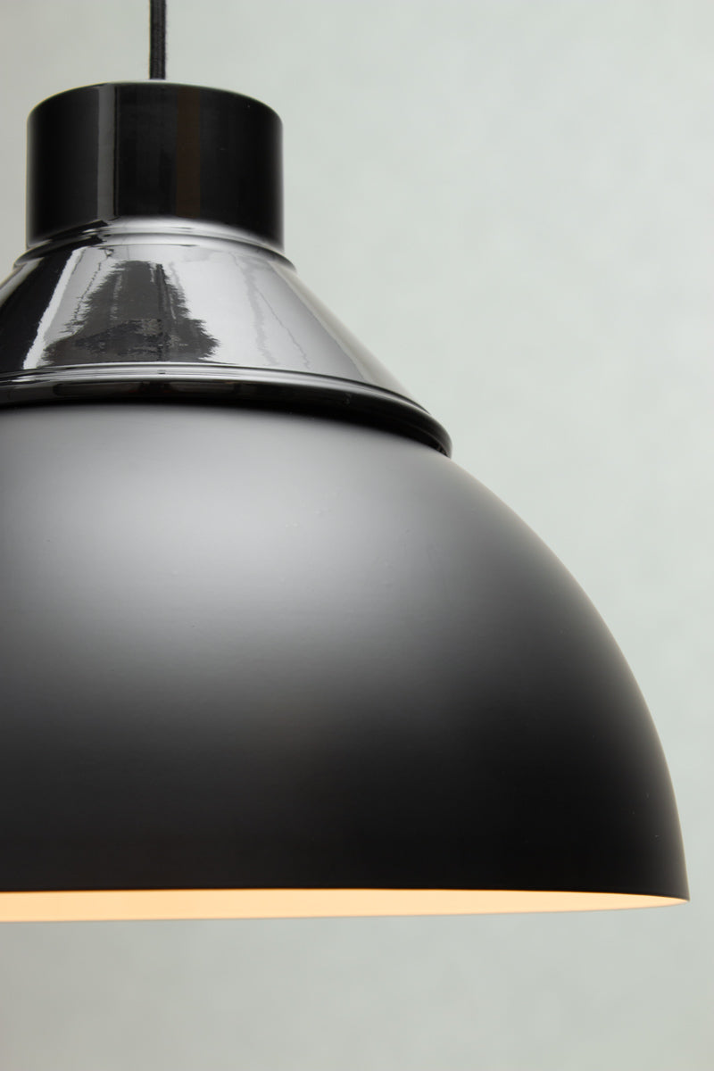 Close-up of the black Dome Foundry Pendant Light showing the industrial metal shade and upper fitting