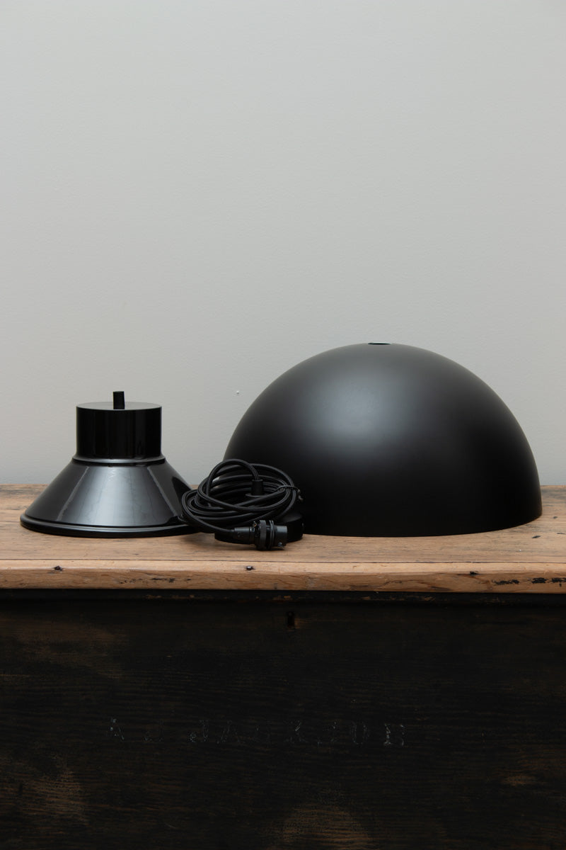 Dome Foundry Pendant Light black metal shade and matching shade cover displayed on a timber surface