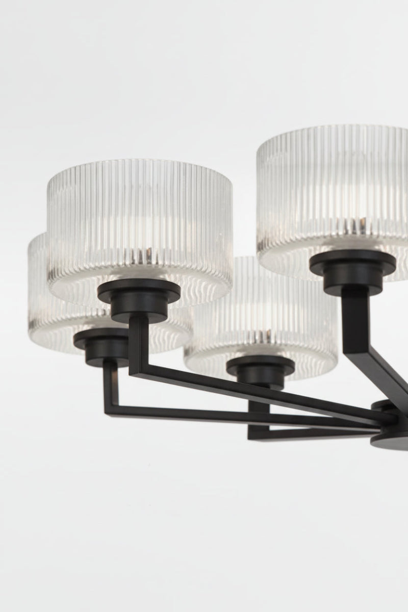 Close up of the Black 8 light chandelier with clear reeded open glass shades. 