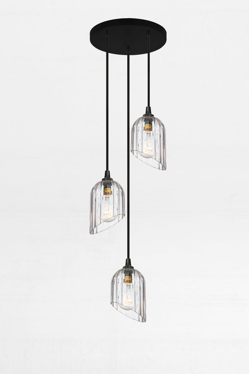 Three fluted clear glass shades with an angled cut detail, paired with a black circular ceiling rose and cords. 