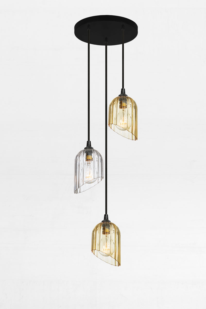 Fluted glass shades with an angled cut detail in amber and clear, paired with a black circular ceiling rose and cords. 