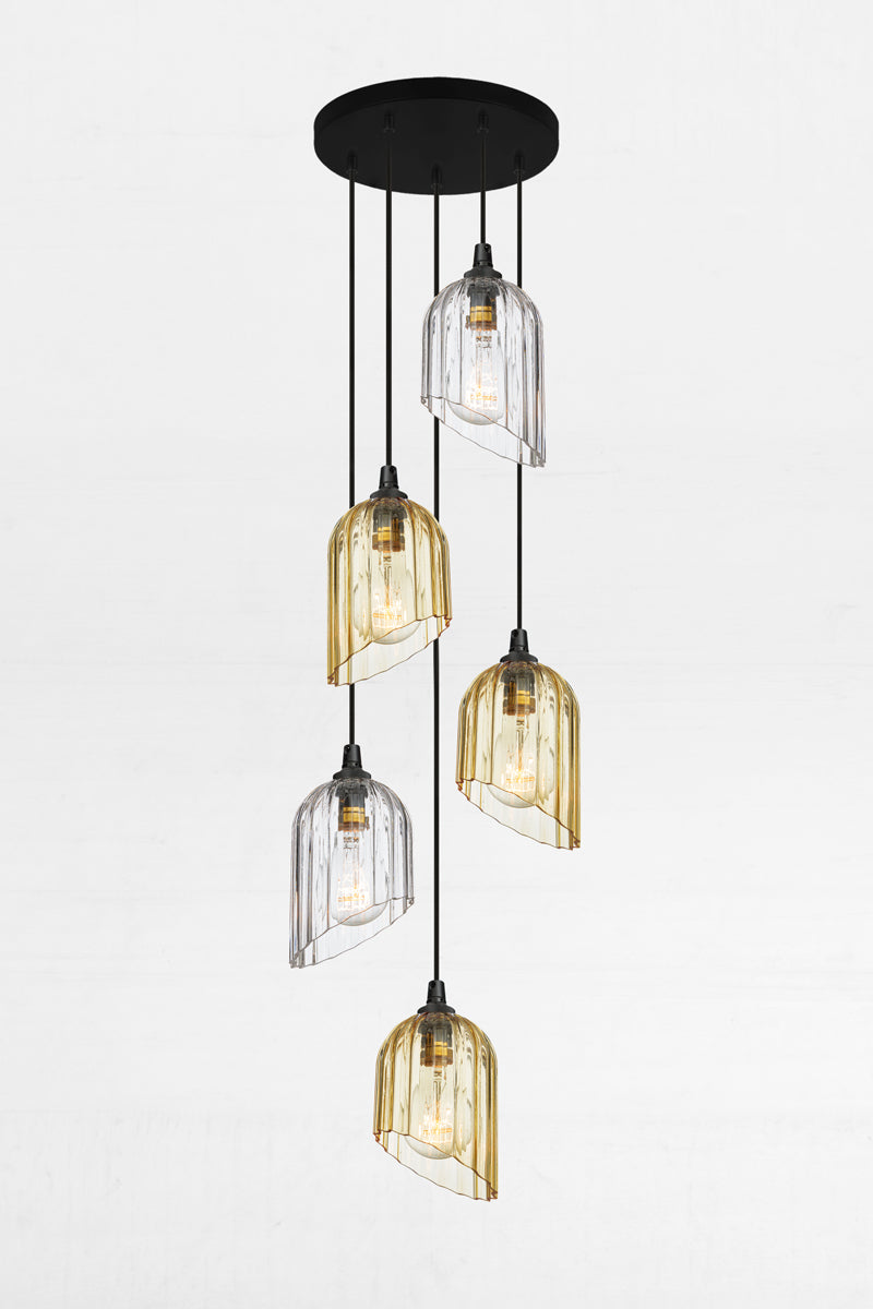Five fluted glass shades in amber and clear with a 60 degree angled cut feature, paired with a black circular ceiling rose and cords. 