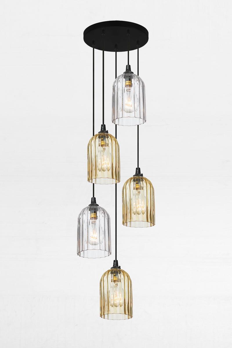 Five fluted glass shades in amber and clear, paired with a black circular ceiling rose and cords. 