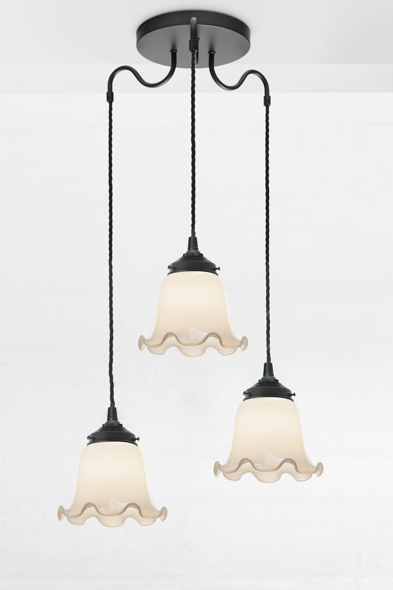 Three light pendant with gooseneck arm, black twisted cloth cords and opal glass shades. 