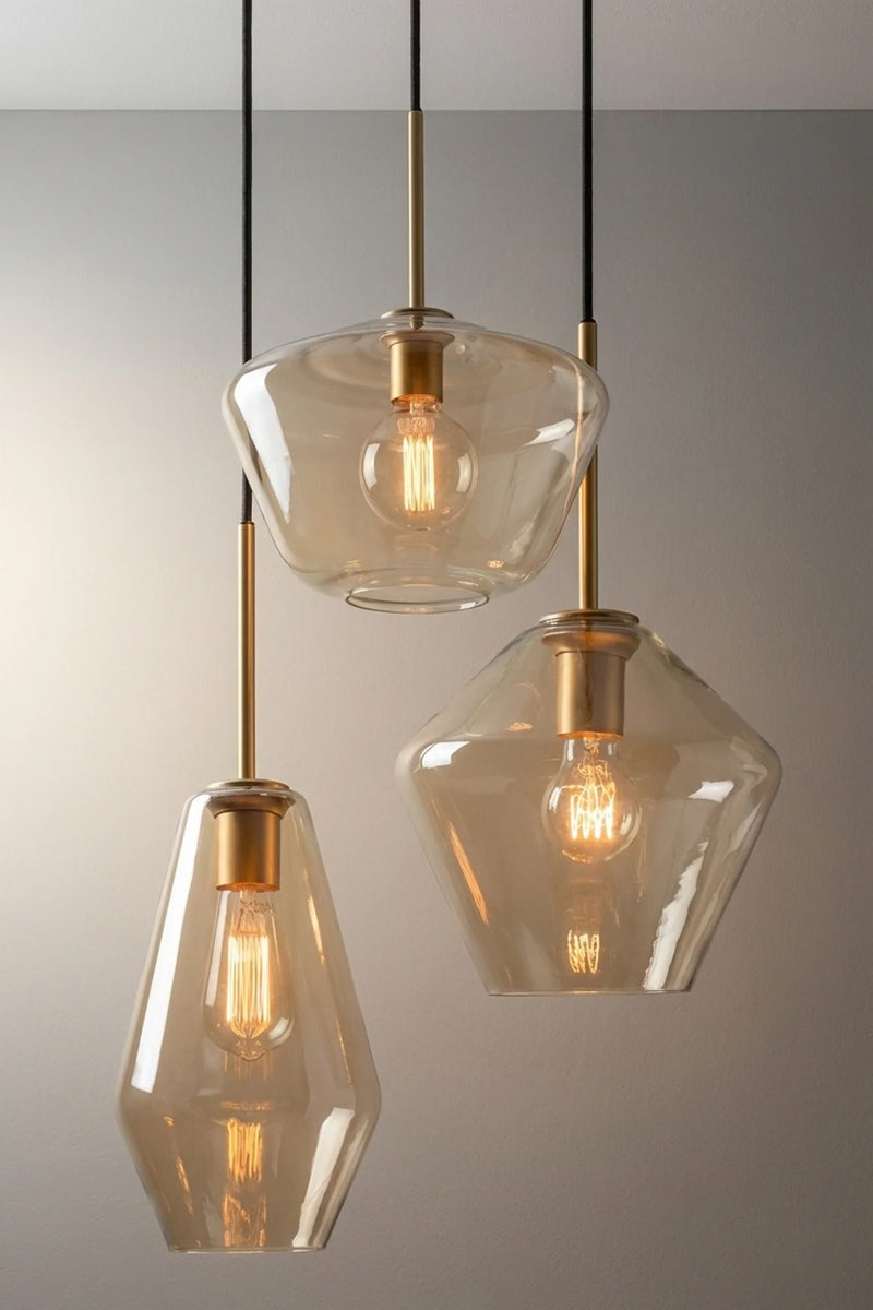 Lugano Glass Multi Drop Pendant – Mixed three drop pendant with Shades A, B and C in champagne glass and black cloth cords and gold/brass metalware. 