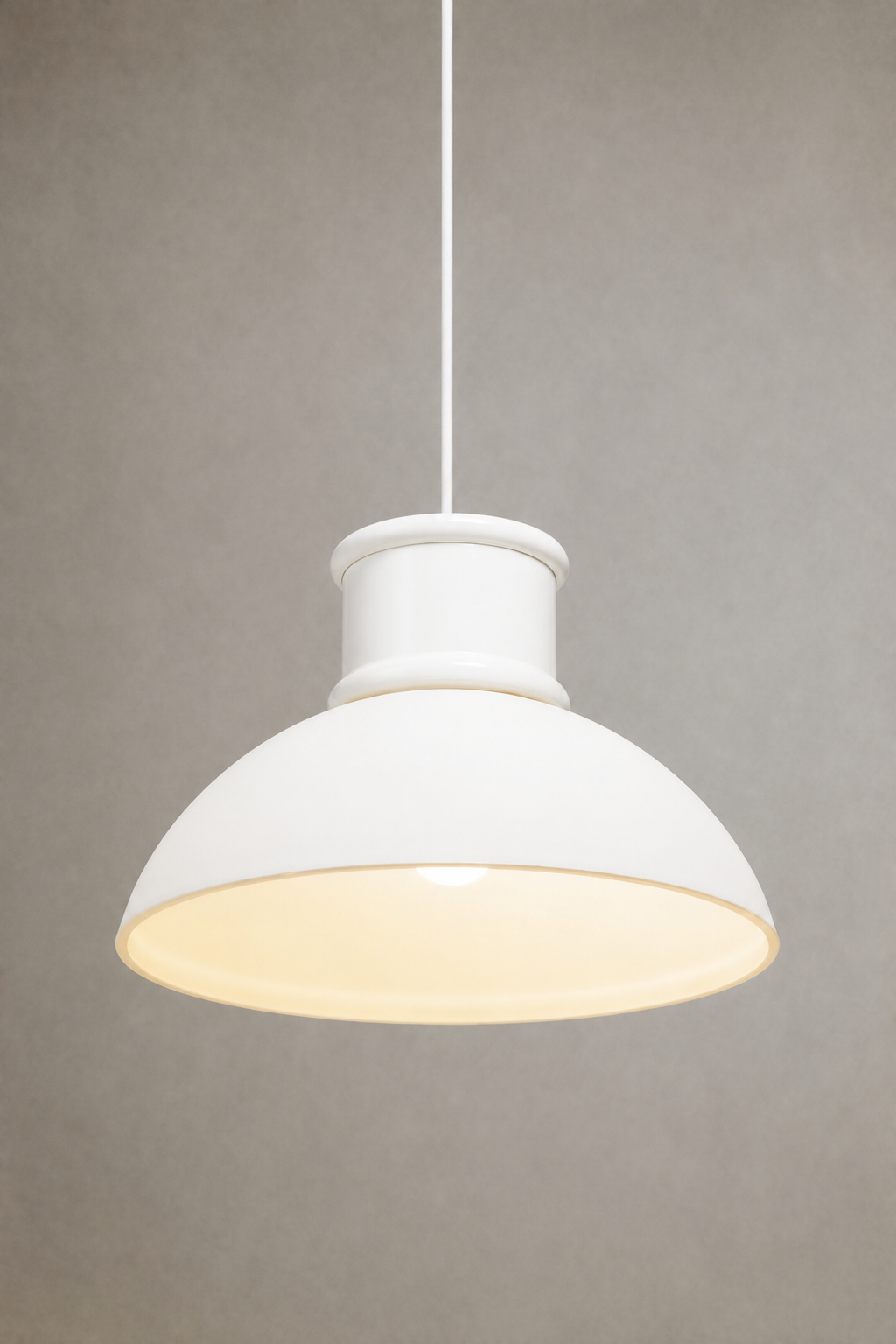 Homestead Brickworks Pendant Light illuminated with a white dome shade, white metal shade cover and white fabric cord