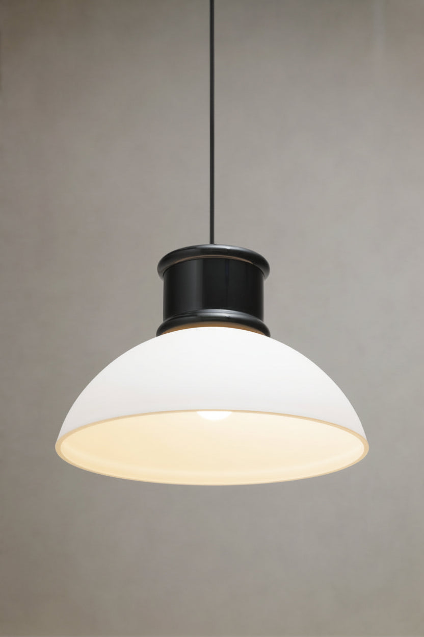 Homestead Brickworks Pendant Light illuminated with a white dome shade, black metal shade cover and black fabric suspension cord