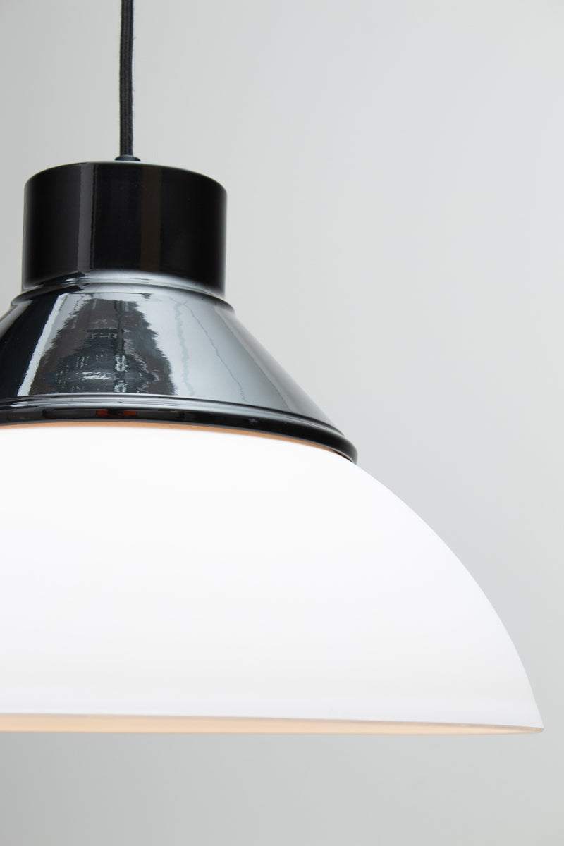 A close-up of Homestead Foundry Pendant Light with a black shade cover and opal glass dome shade. 