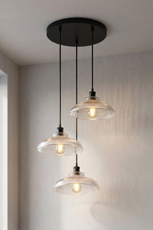 Three holophane-style glass shades together on a single black circular rose to form this Multi Light Pendant